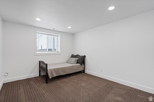 bedroom featuring recessed lighting, dark carpet, and baseboards