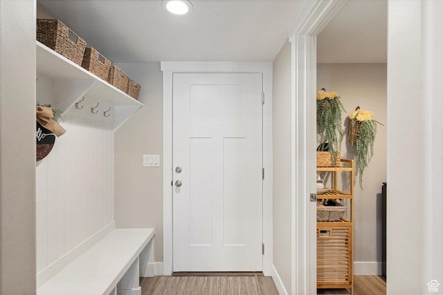 mudroom with baseboards and light wood-style flooring