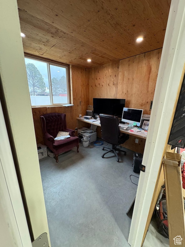 home office with finished concrete floors, recessed lighting, wooden ceiling, and wooden walls