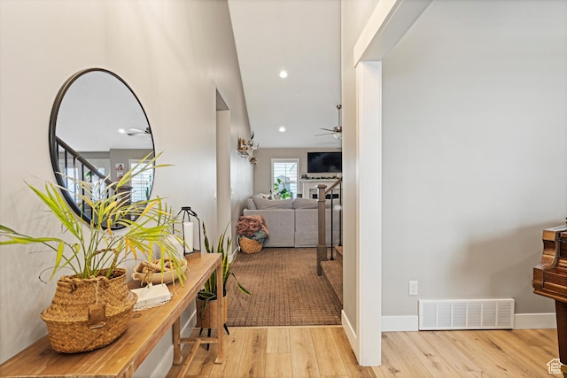 corridor with recessed lighting, baseboards, visible vents, and wood-type flooring