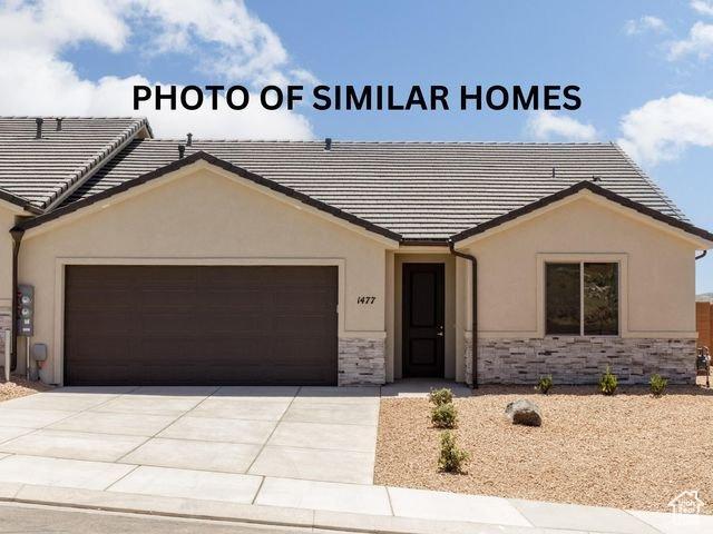 single story home with stone siding, a tiled roof, an attached garage, and concrete driveway