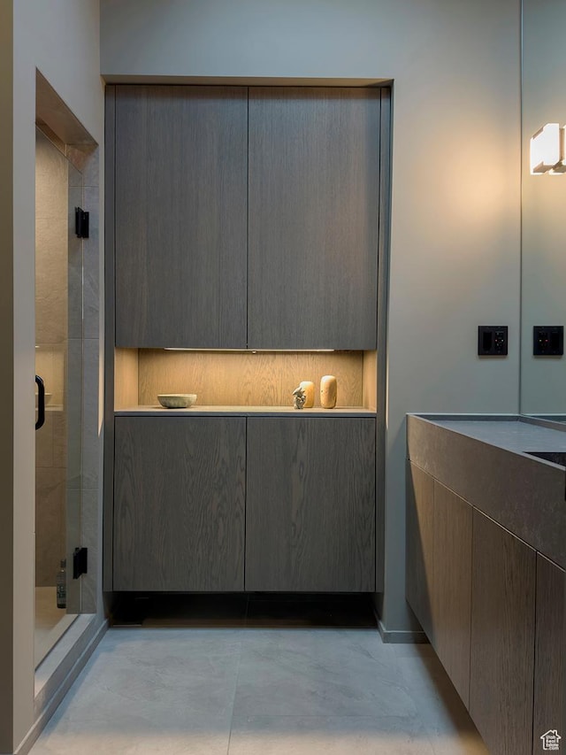 bathroom with tasteful backsplash, a shower stall, and vanity