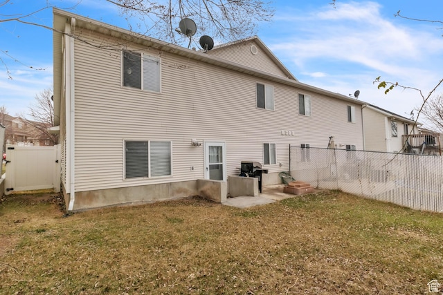 back of house with a yard and fence