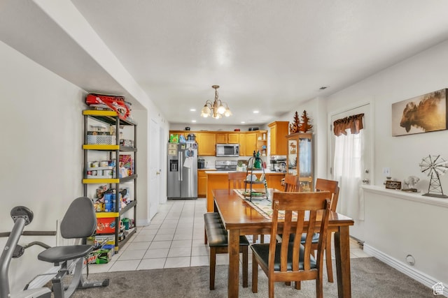 dining area featuring baseboards, light colored carpet, a notable chandelier, and light tile patterned flooring