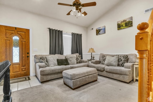 tiled living room featuring lofted ceiling, visible vents, ceiling fan, and carpet