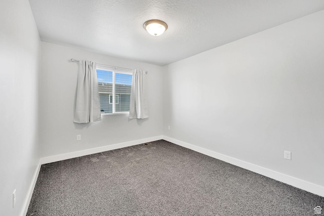 6512 S 390 E, South Weber, UT 84405 - spare room featuring a textured ceiling, dark carpet, and baseboards