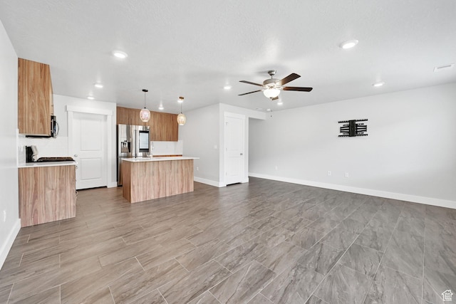 6512 S 390 E, South Weber, UT 84405 - kitchen with stainless steel appliances, light countertops, a ceiling fan, open floor plan, and a kitchen island