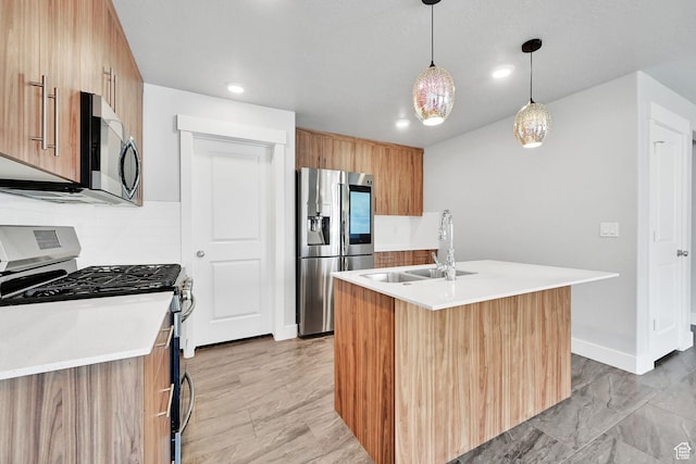 6512 S 390 E, South Weber, UT 84405 - kitchen featuring a sink, light countertops, appliances with stainless steel finishes, hanging light fixtures, and modern cabinets