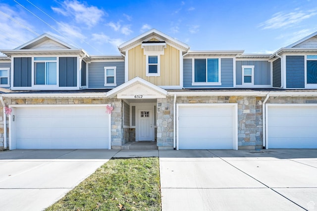6512 S 390 E, South Weber, UT 84405 - view of property featuring board and batten siding, stone siding, driveway, and a garage