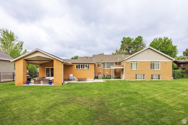 rear view of property with brick siding, outdoor lounge area, and a patio area