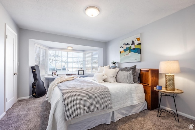 bedroom featuring carpet and baseboards
