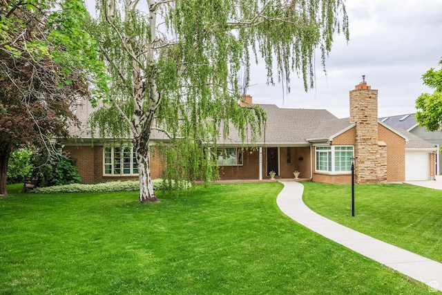 ranch-style home featuring brick siding, a front lawn, roof with shingles, and a garage