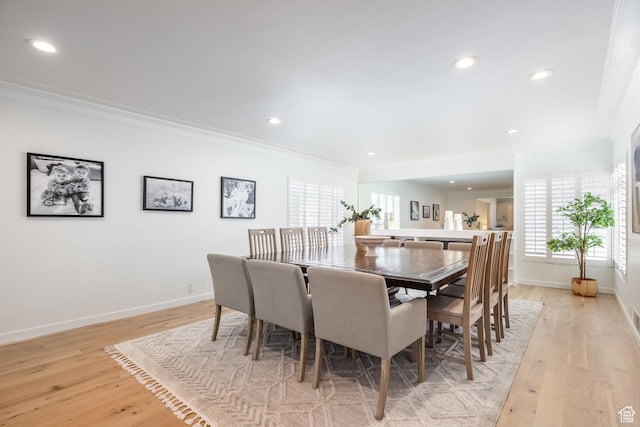 dining area with crown molding, light wood finished floors, baseboards, and recessed lighting