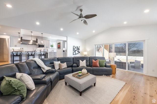 living area with ceiling fan, vaulted ceiling, light wood-style flooring, and recessed lighting
