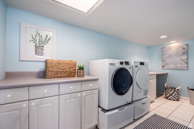 laundry room with washing machine and dryer, cabinet space, light tile patterned flooring, and recessed lighting