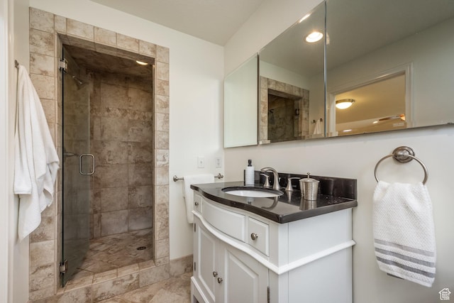 full bathroom featuring a shower stall and vanity