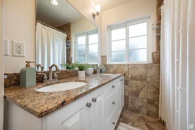 bathroom featuring double vanity, tile walls, and curtained shower