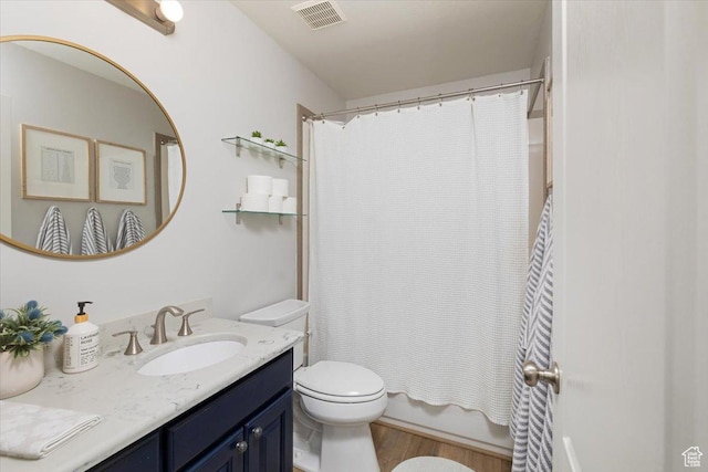 10285 N 7600 W, Tremonton, UT 84337 - full bathroom featuring shower / bath combination with curtain, toilet, wood finished floors, visible vents, and vanity