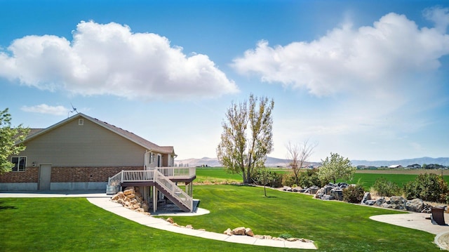 10285 N 7600 W, Tremonton, UT 84337 - view of yard featuring stairs and a deck with mountain view