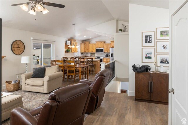 10285 N 7600 W, Tremonton, UT 84337 - living area featuring wood finished floors, baseboards, ceiling fan, vaulted ceiling, and recessed lighting