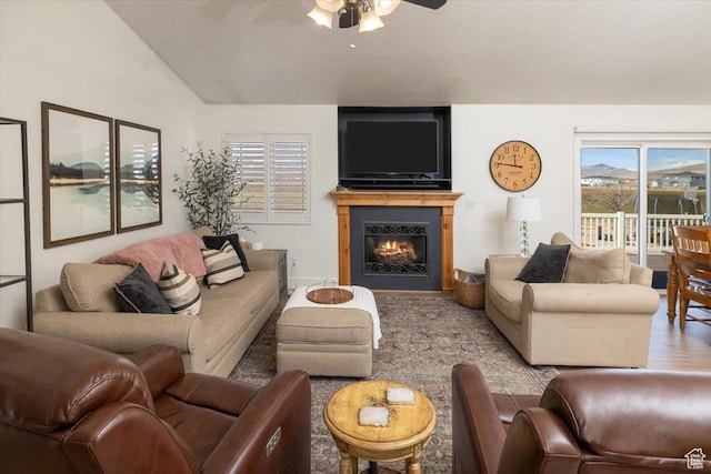 10285 N 7600 W, Tremonton, UT 84337 - living area featuring a ceiling fan, a wealth of natural light, a warm lit fireplace, and wood finished floors