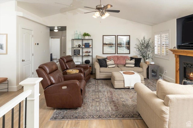 10285 N 7600 W, Tremonton, UT 84337 - living area with a ceiling fan, vaulted ceiling, baseboards, a glass covered fireplace, and wood finished floors