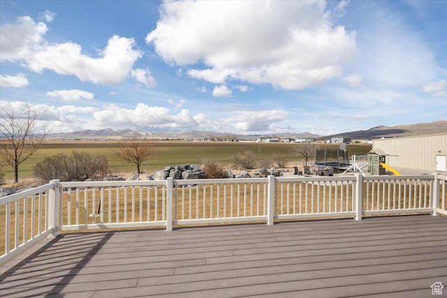 10285 N 7600 W, Tremonton, UT 84337 - wooden terrace featuring a playground, a rural view, and a mountain view