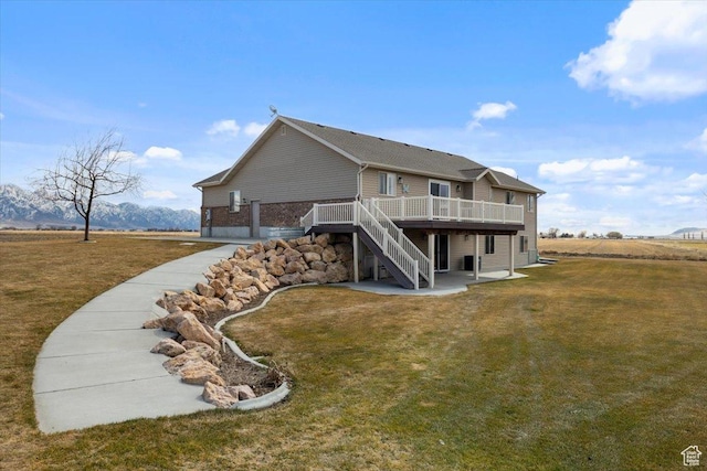 10285 N 7600 W, Tremonton, UT 84337 - back of house with a yard, stairway, a wooden deck, and a patio