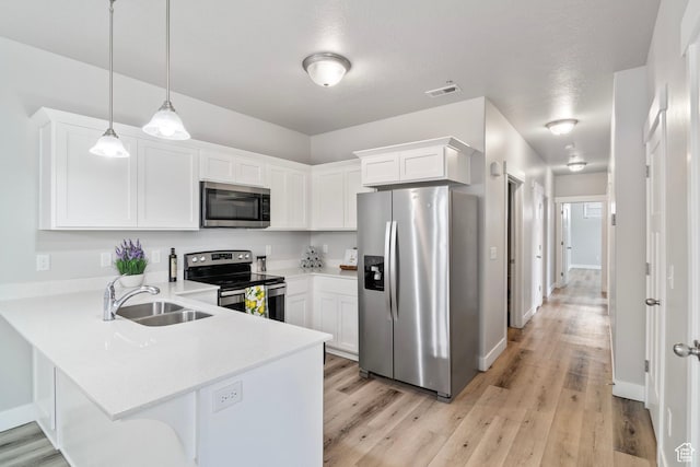 14648 S Mckellen Dr W Unit B203, Herriman, UT 84096 - kitchen featuring stainless steel appliances, a sink, a peninsula, white cabinets, and light countertops