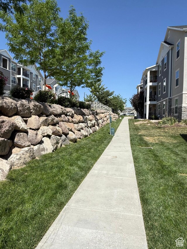 14648 S Mckellen Dr W Unit B203, Herriman, UT 84096 - view of community featuring a residential view and a lawn