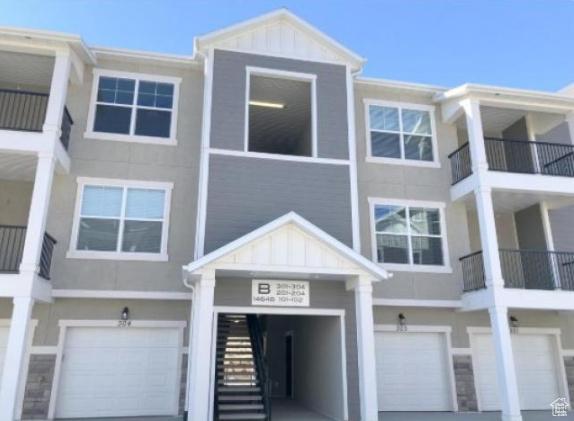 14648 S Mckellen Dr W Unit B203, Herriman, UT 84096 - view of building exterior with an attached garage