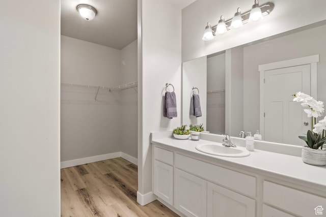 14648 S Mckellen Dr W Unit B203, Herriman, UT 84096 - full bath with vanity, wood finished floors, baseboards, and a walk in closet
