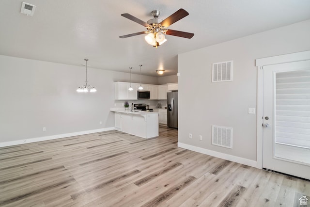 14648 S Mckellen Dr W Unit B203, Herriman, UT 84096 - unfurnished living room with ceiling fan, light wood finished floors, baseboards, and a chandelier