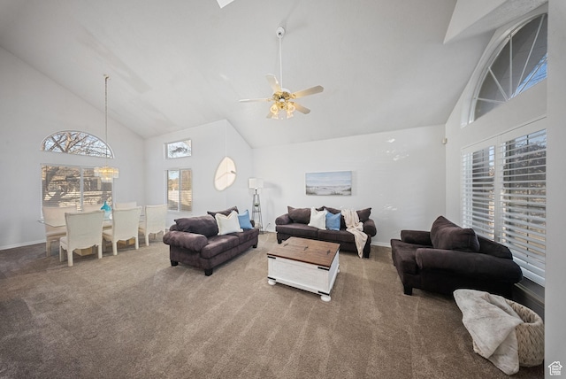 carpeted living room featuring baseboards, high vaulted ceiling, and ceiling fan