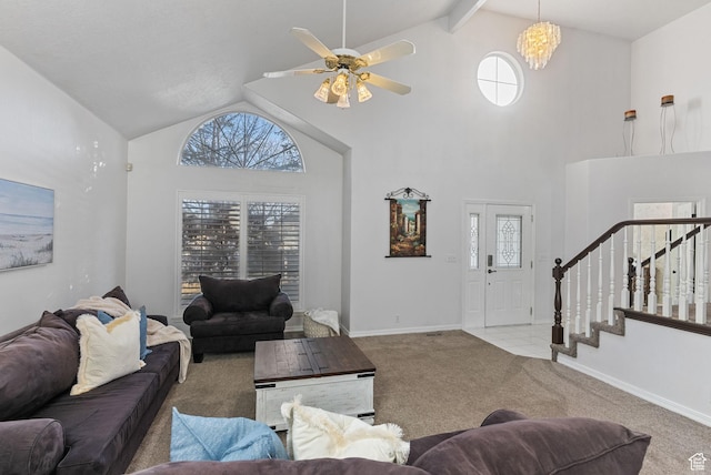 carpeted living area featuring stairway, baseboards, and high vaulted ceiling