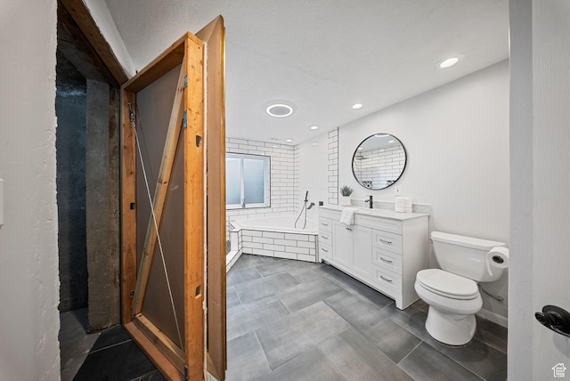 bathroom featuring recessed lighting, toilet, a bath, and vanity