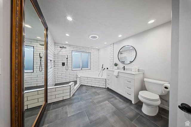 bathroom featuring vanity, recessed lighting, a shower stall, a garden tub, and toilet