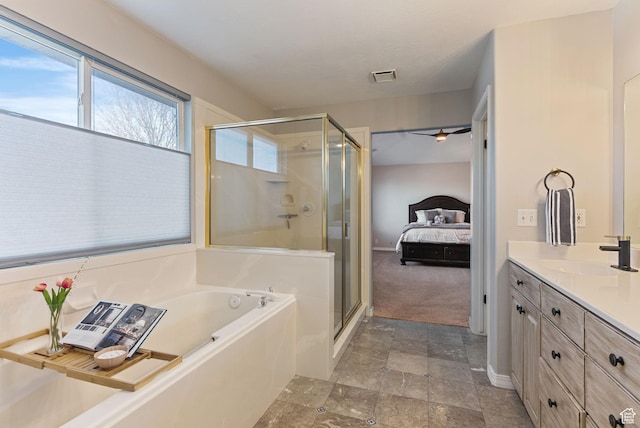 full bathroom with visible vents, a shower stall, ensuite bathroom, a bath, and vanity