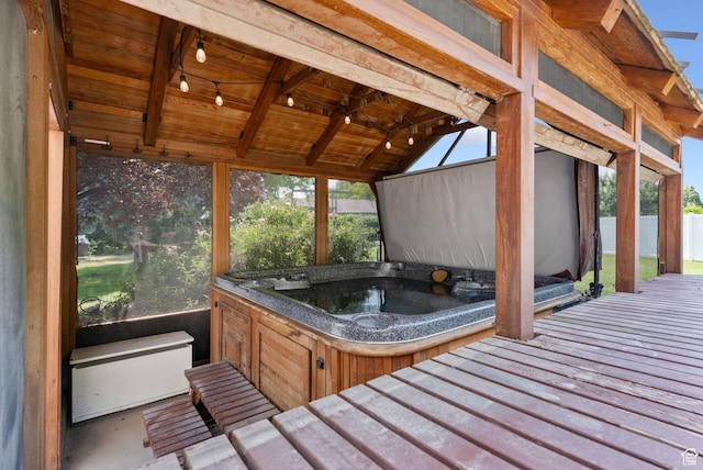 wooden deck with a hot tub