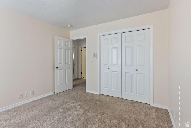 unfurnished bedroom with baseboards and carpet floors