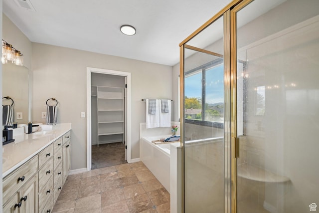 11732 S Lampton View Dr W, South Jordan, UT 84095 - full bathroom featuring double vanity, a garden tub, a stall shower, a walk in closet, and baseboards
