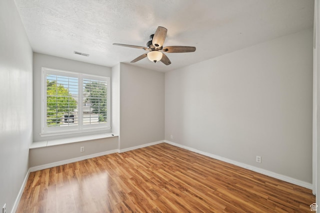 11732 S Lampton View Dr W, South Jordan, UT 84095 - spare room featuring wood finished floors, a ceiling fan, baseboards, and a textured ceiling