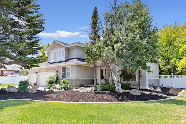 view of front of home featuring a front lawn, fence, stucco siding, a garage, and stone siding