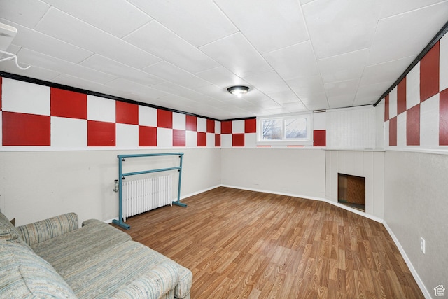 423 N 200 E, Tremonton, UT 84337 - unfurnished room featuring wood finished floors, a fireplace, and baseboards