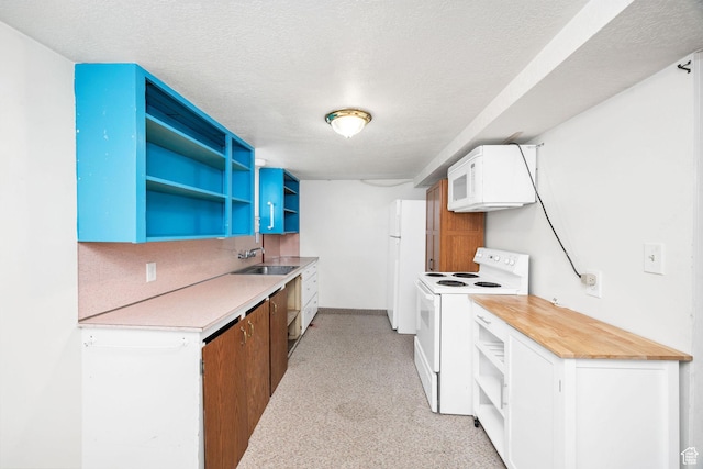 423 N 200 E, Tremonton, UT 84337 - kitchen featuring white appliances, open shelves, a sink, light colored carpet, and light countertops
