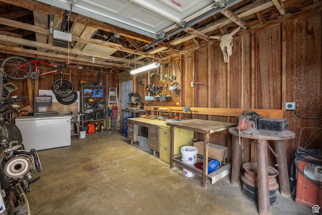 423 N 200 E, Tremonton, UT 84337 - garage featuring a workshop area, a garage door opener, and wood walls