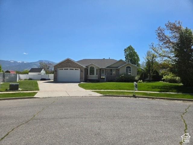 338 N 1090 W, Hyrum, UT 84319 - ranch-style home with concrete driveway, a garage, and a mountain view