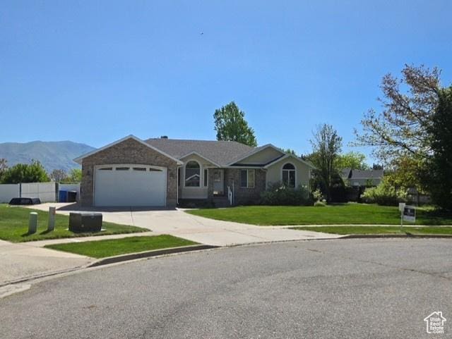 338 N 1090 W, Hyrum, UT 84319 - ranch-style house with a garage, driveway, a front lawn, and a mountain view