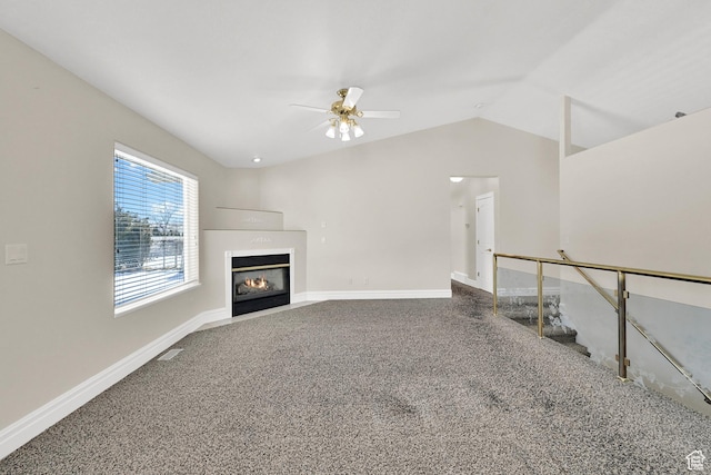 338 N 1090 W, Hyrum, UT 84319 - unfurnished living room featuring a ceiling fan, a glass covered fireplace, lofted ceiling, baseboards, and carpet