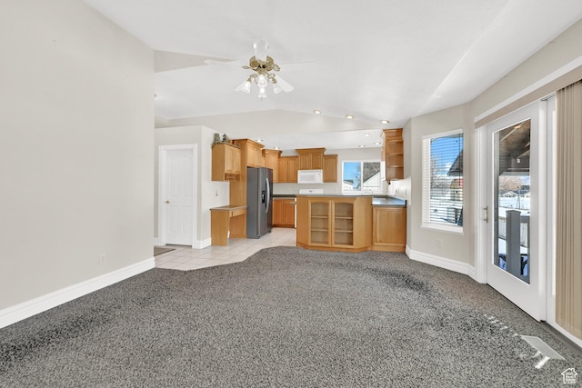 338 N 1090 W, Hyrum, UT 84319 - unfurnished living room featuring light carpet, baseboards, vaulted ceiling, and a ceiling fan